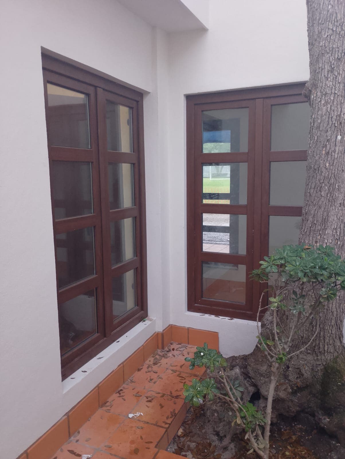 Large format PVC windows with wooden finish in guest accommodation