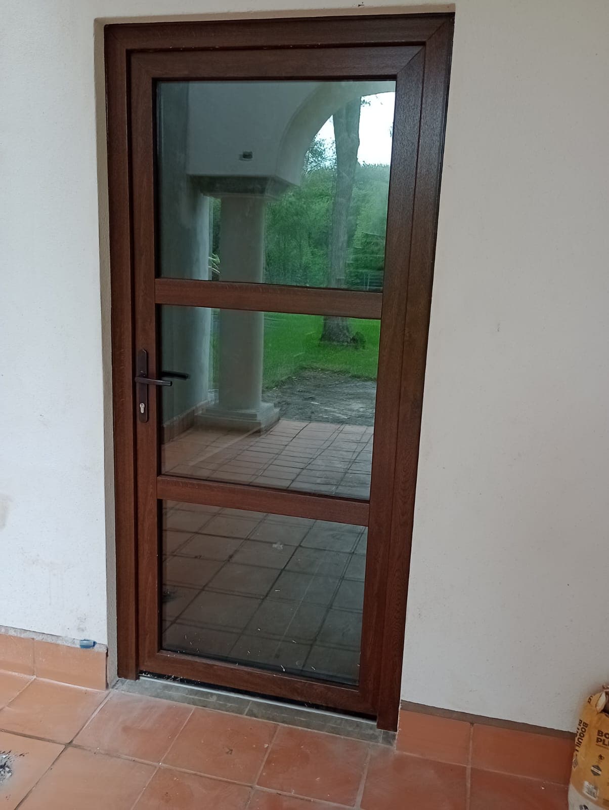 Wooden-finish PVC door with crystal clear glass panel